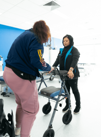 Fahima helping a patient during a rehabilitation session